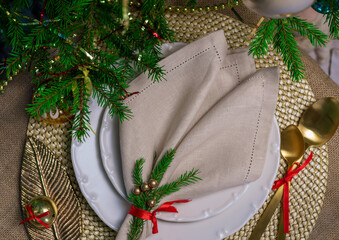 New Year's table setting in gold color with a linen napkin