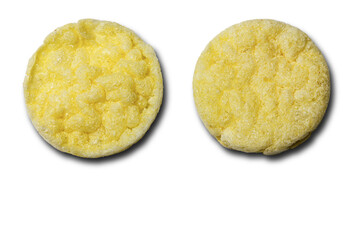 Two round rice chips with cheese flavor on a white background