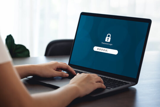 Woman hand typing password security login in laptop computer.