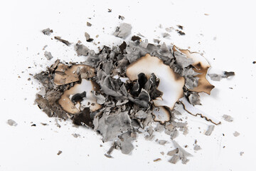pile of burnt paper ashes on white background. 
