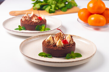 Obraz na płótnie Canvas Delicious chocolate tart garnish with cherry and mint. Classic dessert.