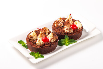 Delicious chocolate tart garnish with cherry and mint. Classic dessert. - 760444582