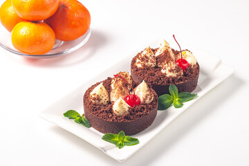 Delicious chocolate tart garnish with cherry and mint. Classic dessert. - 760444599