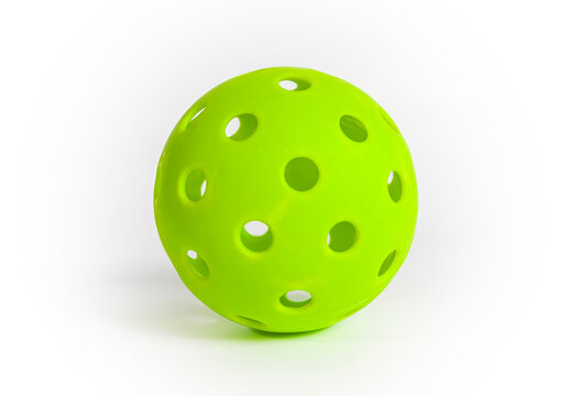 A green pickleball ball isolated on a white background