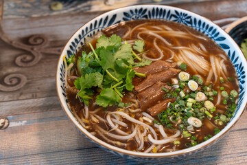 Closeup photo of beef rice noodle (pho), taken in a restaurant