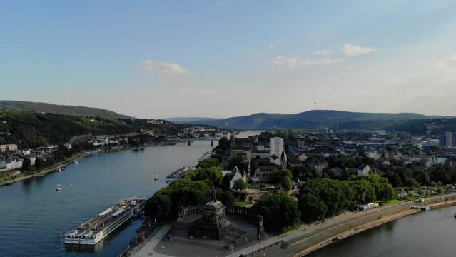 Deutsches Eck or German Corner headland in Koblenz, where the Mosel River joins the Rhine in Koblenz Germany during sunset, Drone aerial view city on the Rhine