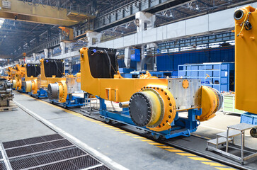 Crawler bulldozer assembly line. Spare parts for assembly on the production line. Heavy industry....