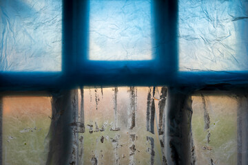 window covered with polyethylene during room paintins in england uk