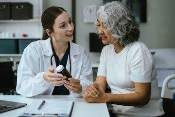 Fototapeta premium Medicine, healthcare and people concept - doctor with tablet pc computer talking to woman patient at clinic.