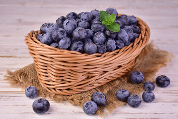 Blueberries in a basket on a wooden background. Close-up.
