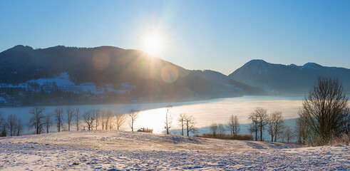 frozen lake Tegernsee and bavarian mountains, tourist resort Grmund, view from above