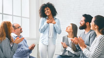 African woman sharing her achievement with rehab group