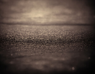 The background, gray asphalt illuminated by dim light. - obrazy, fototapety, plakaty