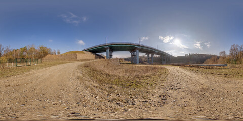 hdri 360 panorama on gravel road near steel frame construction of huge car bridge across river  in...