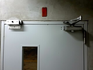 Magnetic Door Lock and Door closer in the car park of the high building