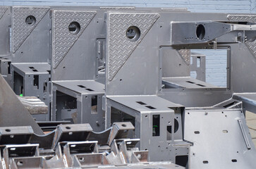 Preparation of welded parts for assembly of crawler dozers and wheel loaders. Storage station spare parts before painting components. Crawler bulldozer assembly line. Heavy industry. © Leszek Szelest