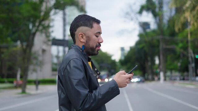 Queer young man using phone stand on street. Mobile technology. Businessman cell modern fashion. Portrait. Outdoor. Slow motion
