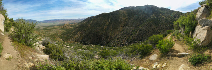 Fototapeta na wymiar A panoramic view of a mountain range with a rocky, barren landscape