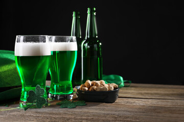 St. Patrick's day party. Green beer, nuts, leprechaun hat and decorative clover leaves on wooden...