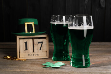 St. Patrick's day celebrating on March 17. Green beer, block calendar, leprechaun hat, gold coins...