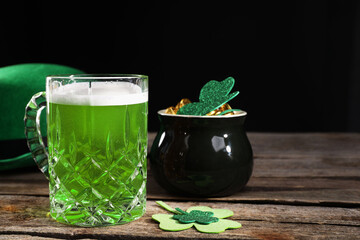 St. Patrick's day party. Green beer, leprechaun hat, pot of gold and decorative clover leaves on...