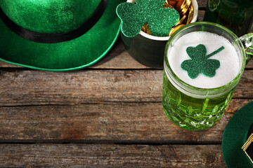 St. Patrick's day party. Green beer, leprechaun hat, pot of gold and decorative clover leaves on...