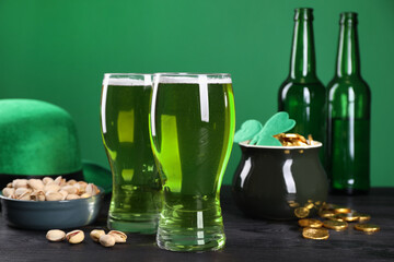 St. Patrick's day party. Green beer, leprechaun hat, pot of gold and pistachios on wooden table