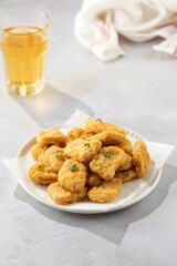 Fast food chicken nuggets paired with a glass of apple juice
