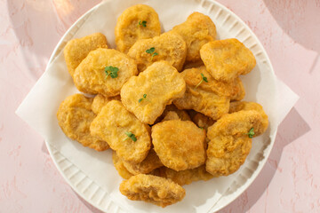 Delicious golden chicken nuggets on a plate close up. Fast food, menu.