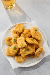 Plate of chicken nuggets on table, fast food dish