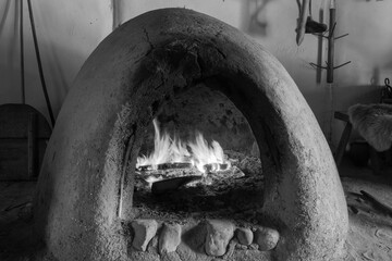 Viking clay oven with fire, black and white