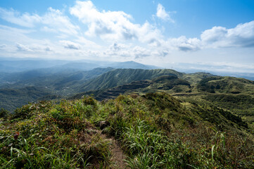 Great view from the peak of Keelung volcano groups, abandoned mining area in the front, cloudy and blue sky, in Jiufen, Jinguashi, New Taipei City, Taiwan.