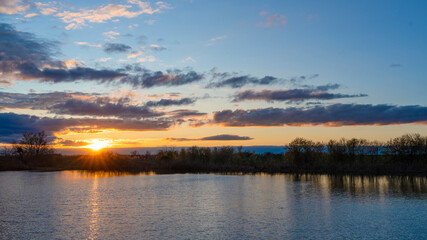Fototapeta na wymiar Beautiful landscape with sunset by the small lake
