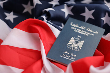 Blue Palestinian Authority passport on United States national flag background close up. Tourism and...