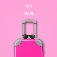 Travel concept. Pink travel suitcase, sunglasses on pink background. Copy space. Travel