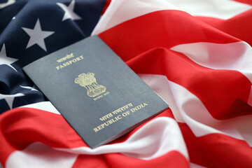 Blue Indian passport on United States national flag background close up. Tourism and diplomacy concept - obrazy, fototapety, plakaty