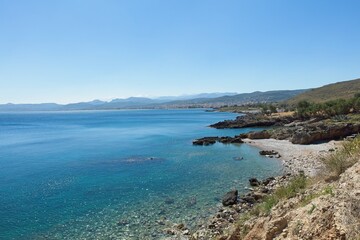 Landscape view of rocky seashore at Trachilos in sunny spring weather, Crete, Greece.
