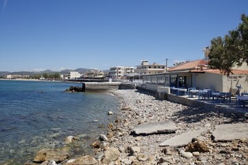 Restaurant on seashore at Kissamos in clear spring weather, Crete, Greece.