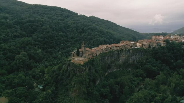 Castellfollit de la Roca - 4K Drone Aerial Flyover - epic landscape of churches, cliffs, canyons, villages and forests - Catalonia Spain - incredible