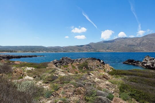 Rocky seashore view across bay from Kissamos ferry port in spring, Crete, Greece.