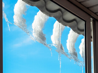 melting snow and icicles turned towards window