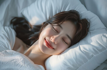 Obraz na płótnie Canvas Portrait of a beautiful korean woman sleeping in bed, smiling with a happy facial expression and a pillow on a white background