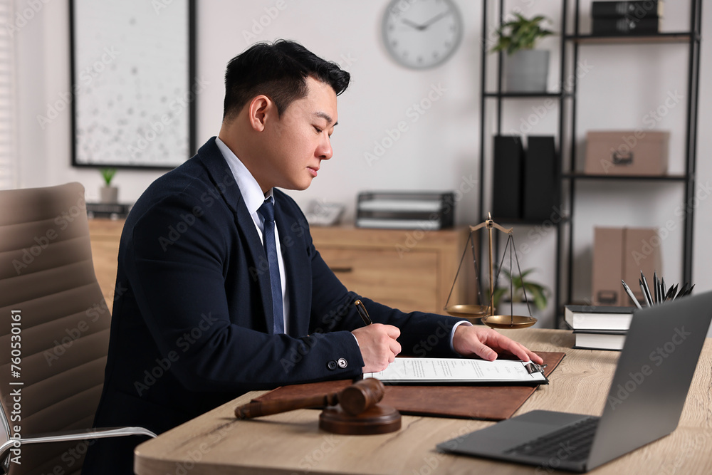 Wall mural Notary writing notes at wooden table in office