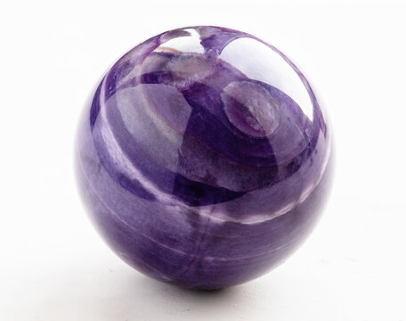ball from natural charoite mineral on white