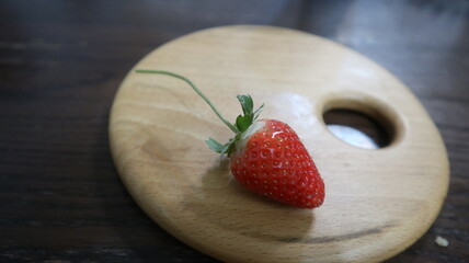 wooden board with red heart and strawberry design for love and romantic concept