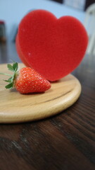 wooden board with red heart and strawberry design for love and romantic concept
