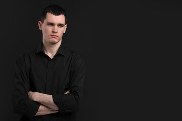 Portrait of sad man on black background, space for text