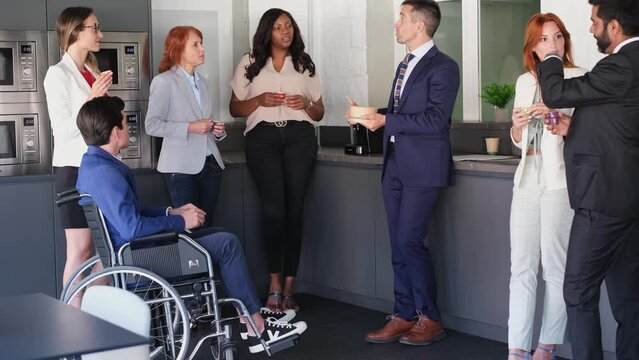 Company committed to disability meeting in a relaxed atmosphere during break time. Concept: business, diversity, integration