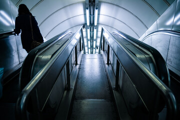 Woman in London underground escalator