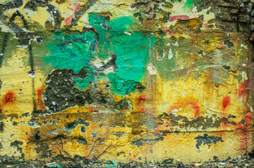 Abstraction from crumbling graffiti on the wall of a city street.
